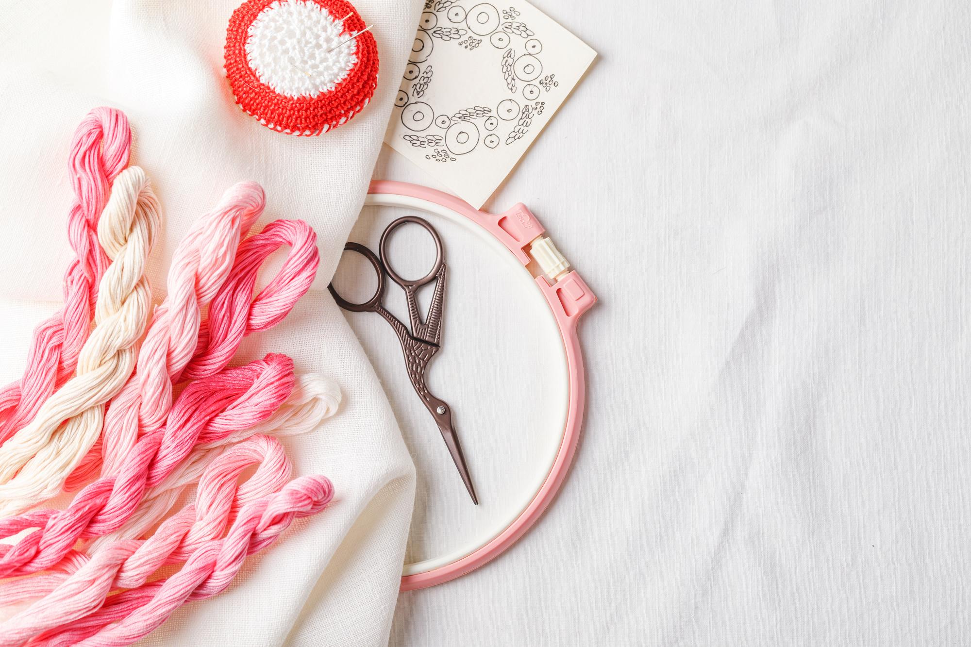 Artist at work stitching floral embroidery